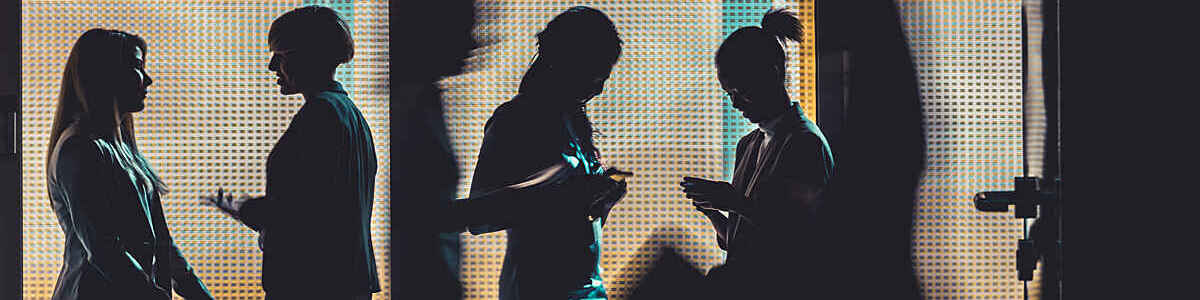 Silhouettes of a group of business people standing or walking in the office building