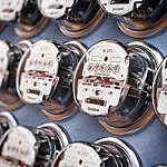 Row of electric meters, measuring power use. 