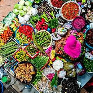 High angle view of vendor selling vegetables at market.