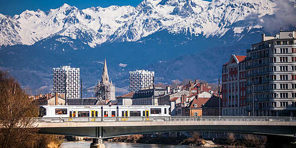 Shot of Grenoble's city centre backed by the Belledonne mountain range.