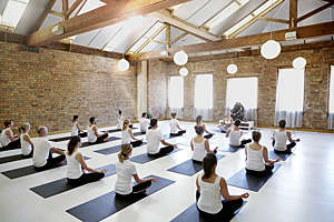 Instructor leading students in a yoga class.