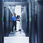 Man using computer in server room