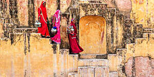 Indian women carrying water from stepwell near Jaipur.